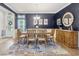 Elegant dining room featuring a wooden table set for six, a stylish rug, and a decorative mirror at 2492 Goldfinch Dr., Myrtle Beach, SC 29577