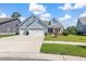 Charming light blue home with a well-manicured lawn and an inviting front porch at 2492 Goldfinch Dr., Myrtle Beach, SC 29577