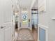Bright hallway with hardwood floors, leading to various rooms and featuring tasteful decorations at 2492 Goldfinch Dr., Myrtle Beach, SC 29577