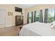 Bright main bedroom features a TV, wood dresser, and large windows with backyard views at 2492 Goldfinch Dr., Myrtle Beach, SC 29577