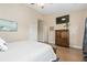 Cozy main bedroom shows a TV, wood dresser, and door to an adjoining bathroom at 2492 Goldfinch Dr., Myrtle Beach, SC 29577