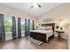 Spacious main bedroom with wood flooring, large windows, and elegant furnishings at 2492 Goldfinch Dr., Myrtle Beach, SC 29577