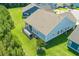 Aerial view of a blue house showcasing a back deck and backyard, offering a private outdoor space at 2492 Goldfinch Dr., Myrtle Beach, SC 29577
