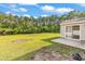 Expansive backyard with a patio area overlooking lush greenery and trees at 2546 Whetstone Ln., Myrtle Beach, SC 29579