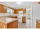 A kitchen features wood cabinets, and white appliances in this brightly-lit space at 2546 Whetstone Ln., Myrtle Beach, SC 29579