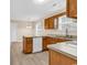 Kitchen with a peninsula, wood cabinets, stainless steel sink and white appliances at 2546 Whetstone Ln., Myrtle Beach, SC 29579