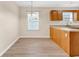 Eat-in kitchen featuring wood cabinets, wood-look floors, and a stylish chandelier at 2546 Whetstone Ln., Myrtle Beach, SC 29579
