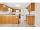 Open kitchen with wood cabinets, white appliances, and a view to the dining area at 2546 Whetstone Ln., Myrtle Beach, SC 29579