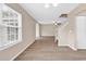 Spacious living room featuring a bright window, white trim, and wood-look flooring at 2546 Whetstone Ln., Myrtle Beach, SC 29579