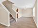 Bright living room featuring a staircase, wood-look flooring, and neutral paint palette at 2546 Whetstone Ln., Myrtle Beach, SC 29579