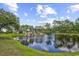 Community pond featuring a waterfall surrounded by trees on a partly cloudy day at 2546 Whetstone Ln., Myrtle Beach, SC 29579