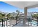 Balcony view of neighboring buildings, blue skies and pool, with table and chairs for relaxing at 307 74Th Ave. N # 3C, Myrtle Beach, SC 29572