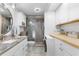 Well-lit bathroom with marble vanity, tiled shower, washer, and ample cabinet storage at 307 74Th Ave. N # 3C, Myrtle Beach, SC 29572