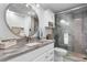 Bright bathroom featuring a marble vanity, modern fixtures, and a glass-enclosed shower at 307 74Th Ave. N # 3C, Myrtle Beach, SC 29572