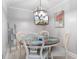 Cozy dining area featuring a round table, coastal decor, and modern lighting with beach view TV at 307 74Th Ave. N # 3C, Myrtle Beach, SC 29572