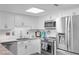Well-lit kitchen featuring stainless steel appliances, white cabinets, and a stylish countertop at 307 74Th Ave. N # 3C, Myrtle Beach, SC 29572