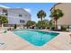A refreshing community pool with lounge chairs and lush landscaping between properties at 307 74Th Ave. N # 3C, Myrtle Beach, SC 29572