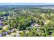Aerial view of a community with mature trees, houses and a golf course nearby at 3071 Alice Ln., Little River, SC 29566
