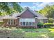 Well-maintained backyard featuring a brick home, patio, and manicured landscaping at 3071 Alice Ln., Little River, SC 29566