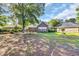 Large backyard with a well-maintained lawn, mature trees, and a brick home at 3071 Alice Ln., Little River, SC 29566