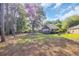 Spacious backyard featuring mature trees, a well-maintained lawn, and a brick home at 3071 Alice Ln., Little River, SC 29566