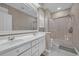 Bathroom with double sink vanity, large mirror, and shower with glass door at 3071 Alice Ln., Little River, SC 29566