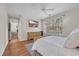 Bright bedroom includes a ceiling fan, decorative rug, and large window with a backyard view at 3071 Alice Ln., Little River, SC 29566