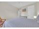 Cozy bedroom with a queen bed, dresser, beach painting, and a window letting in natural light at 3071 Alice Ln., Little River, SC 29566