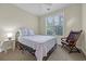 Bright bedroom featuring a full-sized bed, a window letting in natural light, and chair in the corner of the room at 3071 Alice Ln., Little River, SC 29566