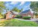 Exterior view of a brick home with a manicured lawn and driveway leading to an attached two-car garage at 3071 Alice Ln., Little River, SC 29566