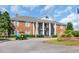 Grand brick building featuring prominent white columns and manicured landscaping at 3071 Alice Ln., Little River, SC 29566