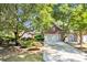 Traditional brick home featuring mature landscaping, a spacious driveway, and an attached two-car garage at 3071 Alice Ln., Little River, SC 29566