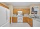 Bright kitchen featuring white appliances, lots of cabinet space and light countertops at 3071 Alice Ln., Little River, SC 29566