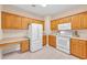 Bright kitchen featuring white appliances, lots of cabinet space and light countertops, and adjacent work space at 3071 Alice Ln., Little River, SC 29566