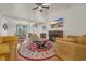 Cozy living room with a fireplace, ceiling fan, and views into the dining area at 3071 Alice Ln., Little River, SC 29566