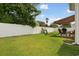 Expansive, fenced backyard with a grassy area and patio with an awning and outdoor seating at 309 Rycola Circle, Surfside Beach, SC 29575