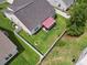 Aerial view of fenced backyard featuring green lawn, mature trees, and striped retractable awning at 309 Rycola Circle, Surfside Beach, SC 29575
