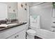 Well-lit bathroom featuring shower over tub and granite vanity countertop and sink at 309 Rycola Circle, Surfside Beach, SC 29575