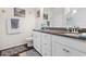 Well-lit bathroom featuring double sinks, granite countertops, and white cabinetry at 309 Rycola Circle, Surfside Beach, SC 29575