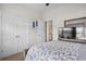 Neutral bedroom showcasing quilt-covered bed, mirrored dresser, a ceiling fan and double closets at 309 Rycola Circle, Surfside Beach, SC 29575