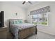 Cozy bedroom with a patterned quilt and decor, featuring a ceiling fan and a window at 309 Rycola Circle, Surfside Beach, SC 29575
