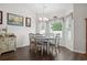 Bright dining area with large windows, decorative curtains, and hardwood flooring at 309 Rycola Circle, Surfside Beach, SC 29575