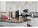 Granite counters accent the stainless appliances in this open kitchen with pantry access at 309 Rycola Circle, Surfside Beach, SC 29575