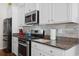Stylish kitchen with stainless steel appliances and granite countertops at 309 Rycola Circle, Surfside Beach, SC 29575