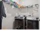 Efficient laundry room equipped with modern washer and dryer units and shelving for storage at 309 Rycola Circle, Surfside Beach, SC 29575