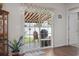 Inviting patio seen from inside through sliding doors, featuring a retractable awning and outdoor seating at 309 Rycola Circle, Surfside Beach, SC 29575