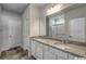 Bathroom with double sink vanity with granite countertops, and framed mirror reflecting the shower at 319 Garden Grove St, Conway, SC 29526