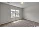 Cozy bedroom with plush carpeting and a bright window offering a pleasant neighborhood view at 319 Garden Grove St, Conway, SC 29526