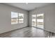 Bright bedroom featuring wood-look flooring, a large window, and sliding glass doors to the outside at 319 Garden Grove St, Conway, SC 29526