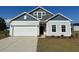 Charming single-Gathering home with a two-car garage, light siding, and beautiful architectural detail at 319 Garden Grove St, Conway, SC 29526